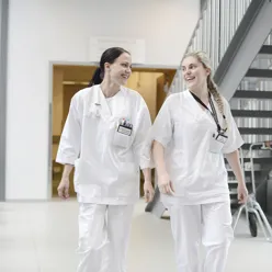 A couple of women in white lab coats