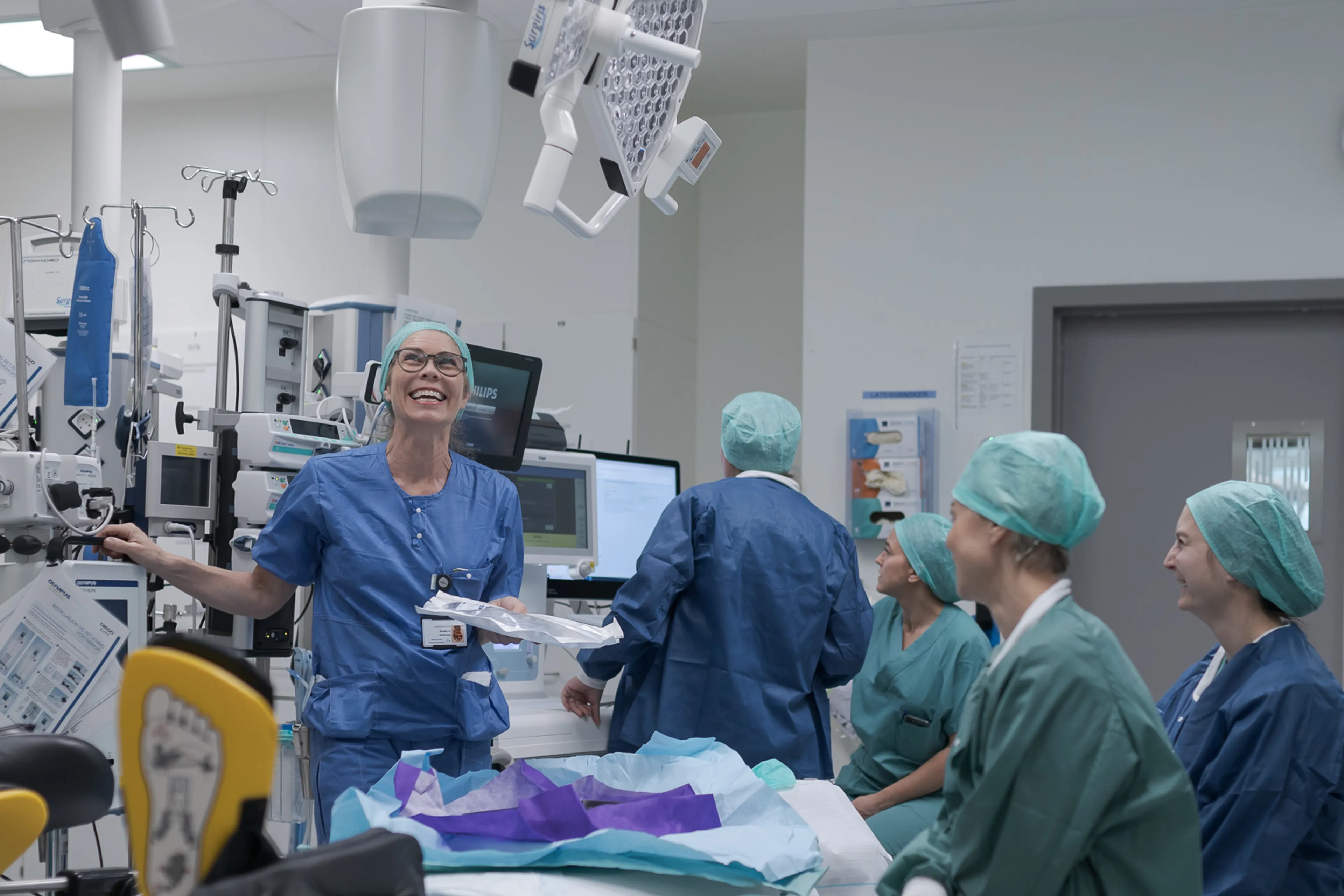 A group of people in surgical scrubs in a room
