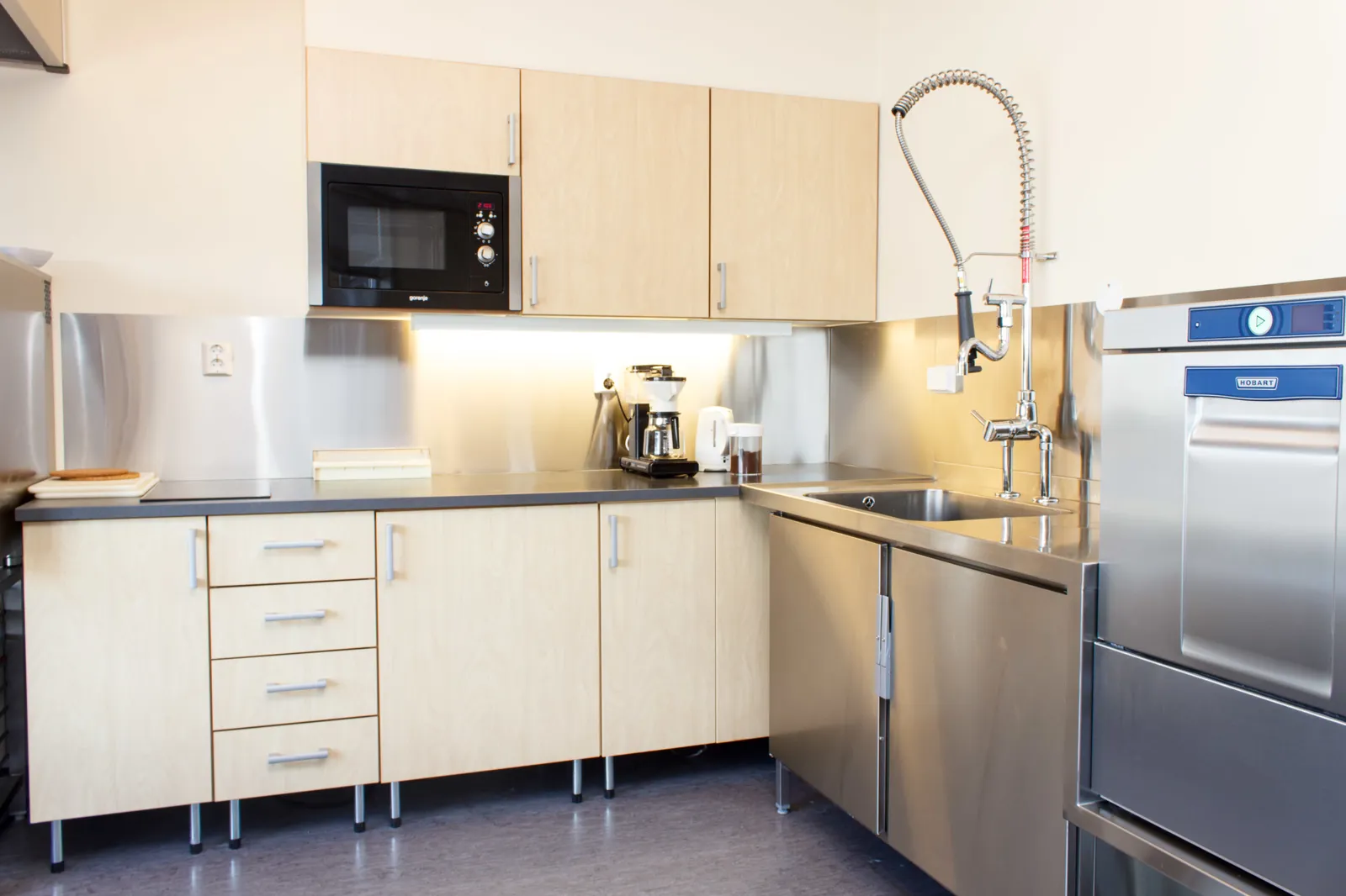 Et kjøkken med hvitevarer i rustfritt stål