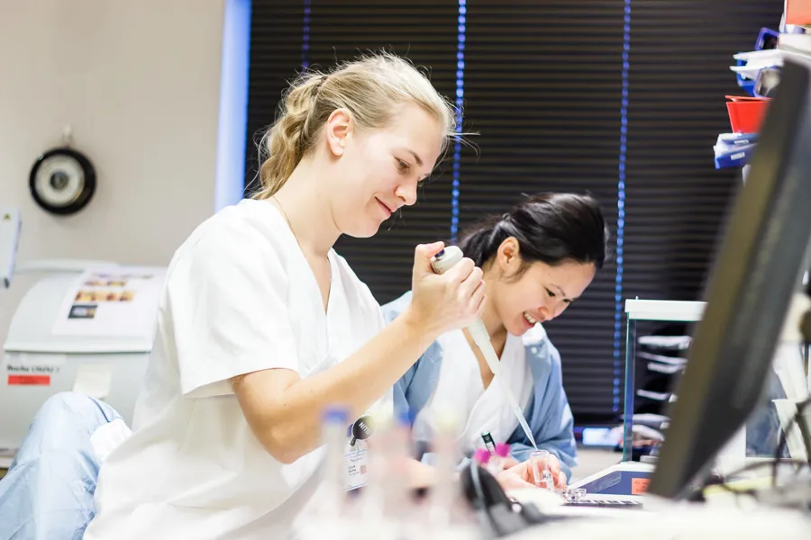 A person showing a patient something on the computer